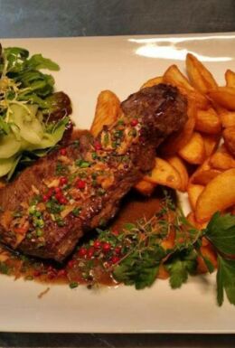 Speisenteller Restaurant Logierhof mit Fleisch, Kartoffelspalten und Salatbeilage