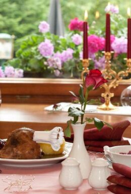 Gedeckter Tisch im Waldhotel Rennsteighof mit Rotwein, Gänsekeule und Thüringer Klößen