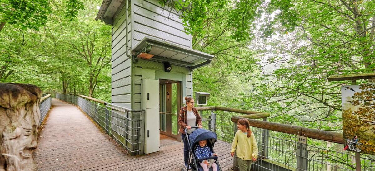 Familie vor dem Aufzug auf dem Baumkronenpfad im Nationalpark Hainich