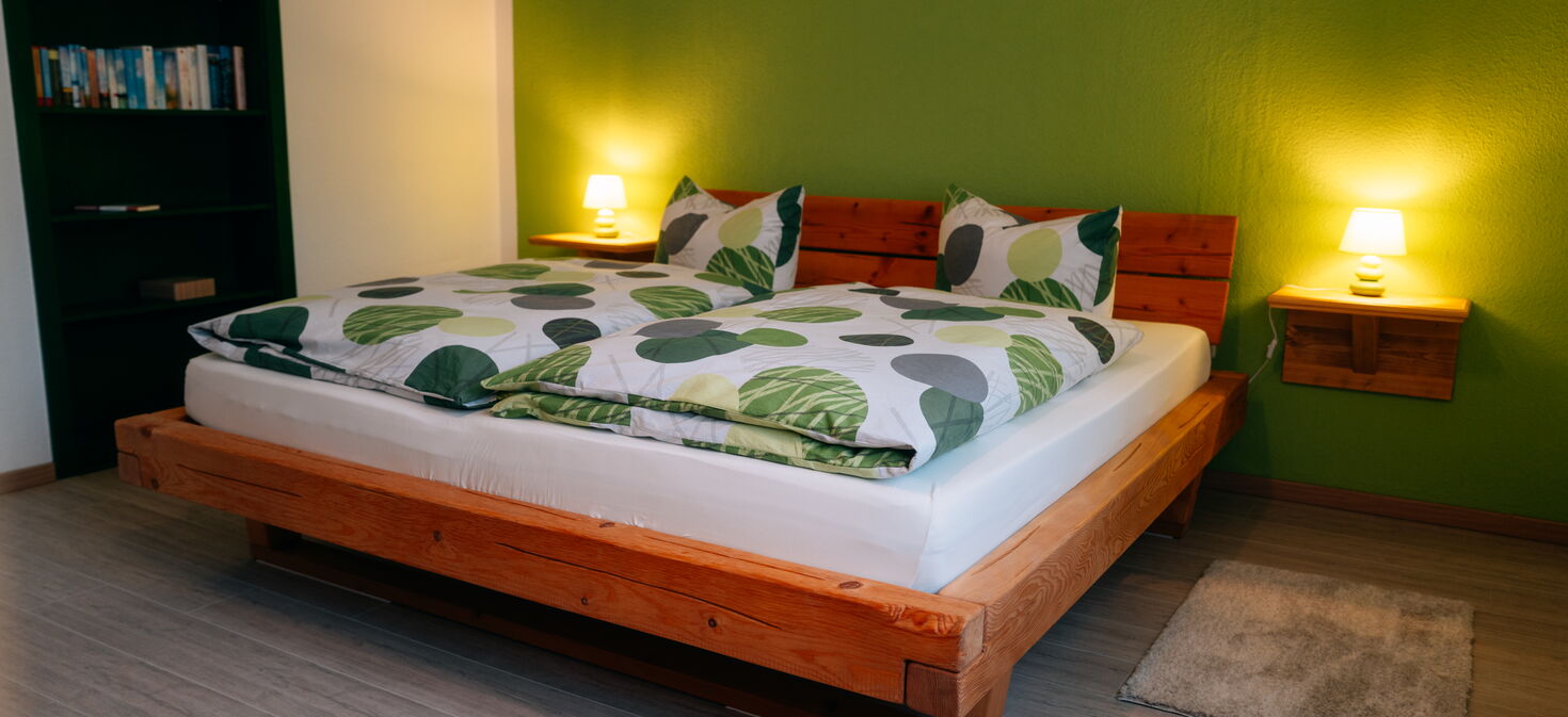 Innenaufnahme Schlafzimmer mit Doppelbett und Bücherregal
